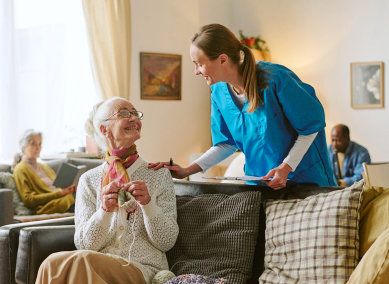 aide and senior woman looking at each other