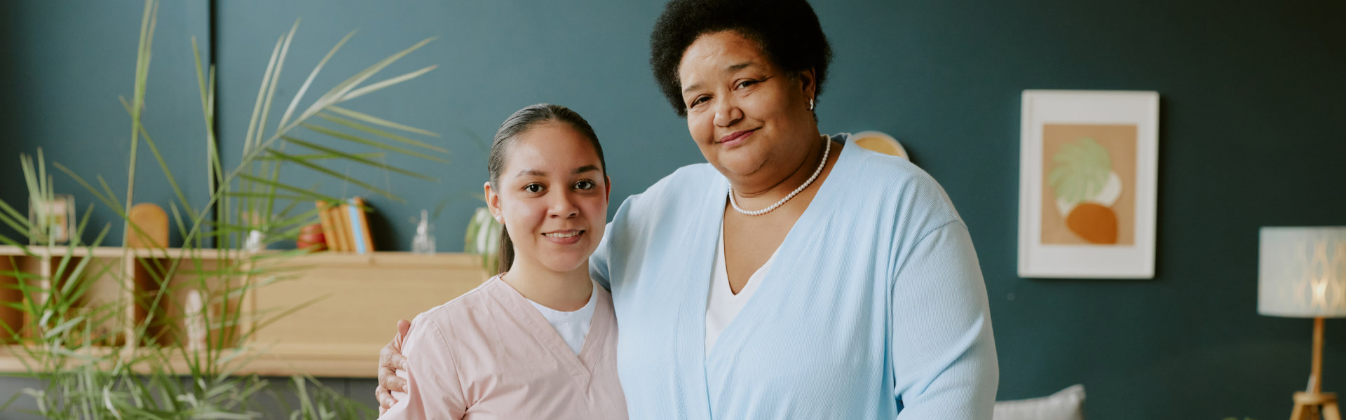 aide and senior woman smiling