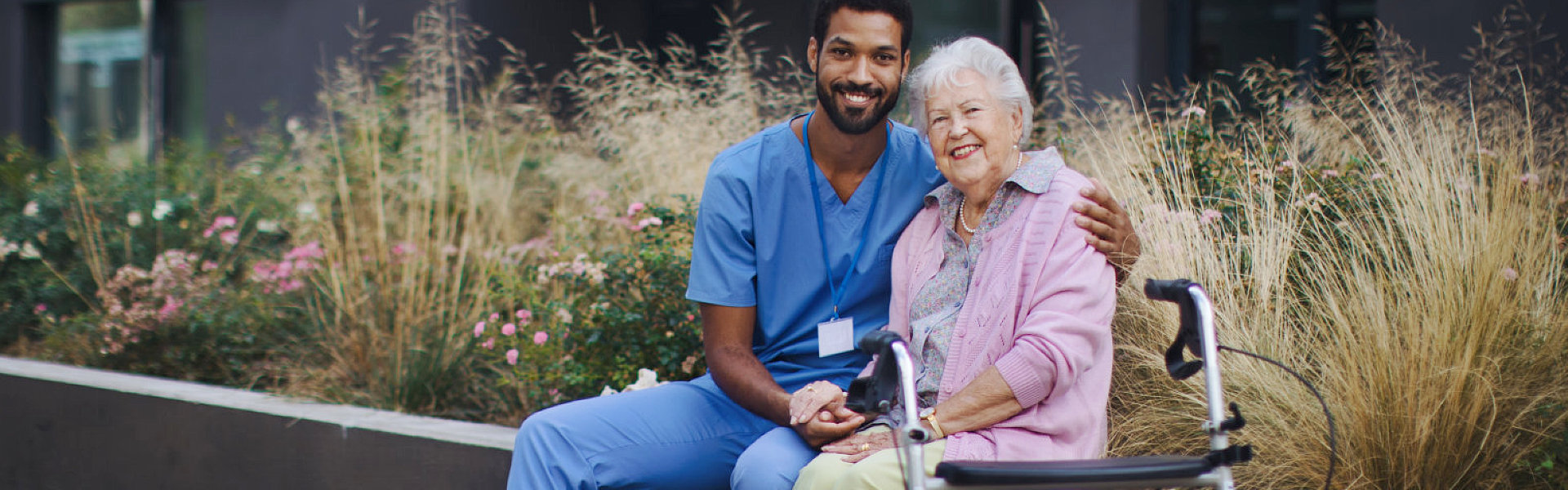 aide and senior woman smiling