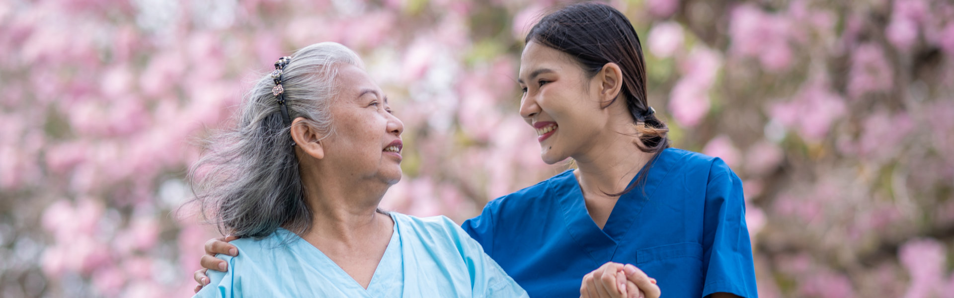 aide and senior woman looking at each other