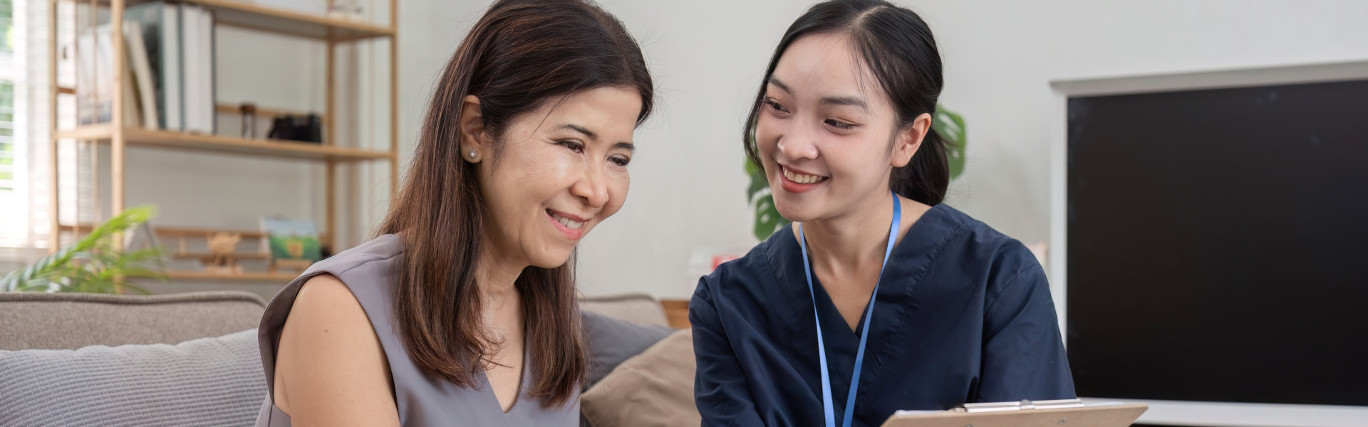 aide smiling at the senior woman
