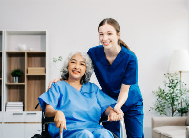 aide and senior woman smiling