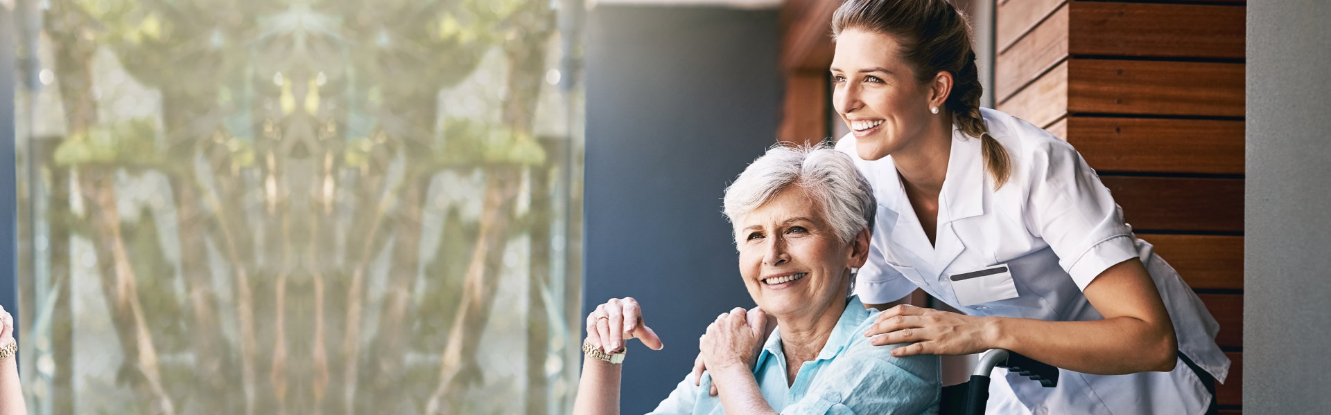 aide and senior woman smiling