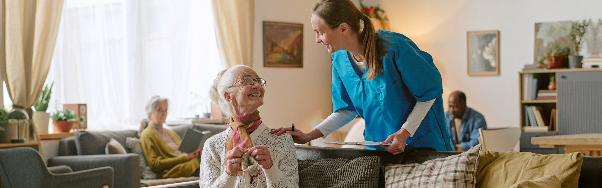 aide and senior woman having a conversation